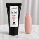 NAILINO Acrylgel Soft Nude Cover Tube und Nagelmodell in sanften Nude-Tönen auf einem Tisch.