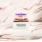 NAILINO Glitzer Farbgel Galactic Glow in eleganter Verpackung auf Marmortisch