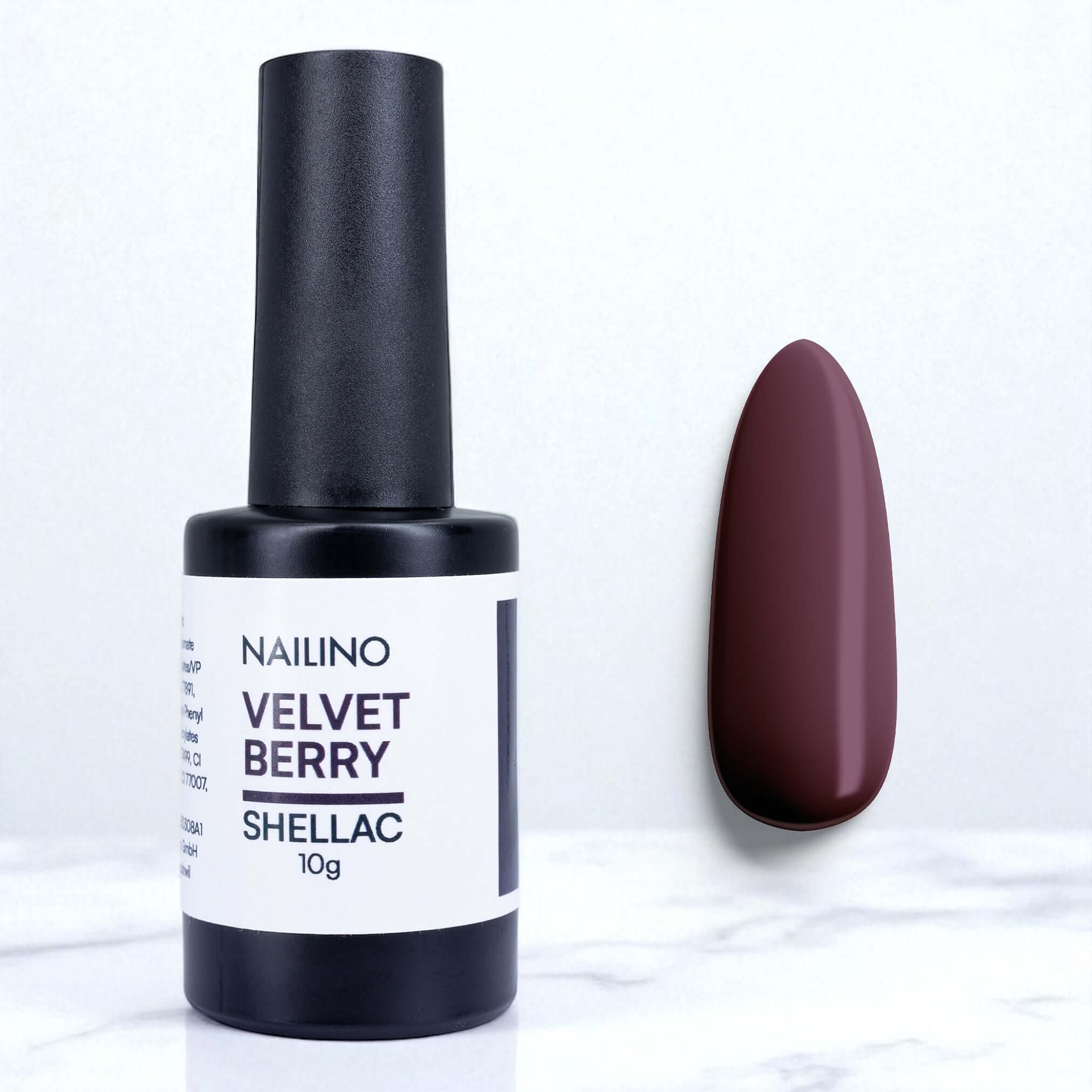 NAILINO Shellac Velvet Berry bottle and swatch showcasing deep berry violet color on a marble background.
