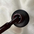 Image of NAILINO Shellac Velvet Berry bottle with dark berry color, showcasing the luxurious shellac polish.