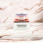 NAILINO Farbgel Violet Whisper in elegant packaging on a marble surface, perfect for stylish and sophisticated nails.